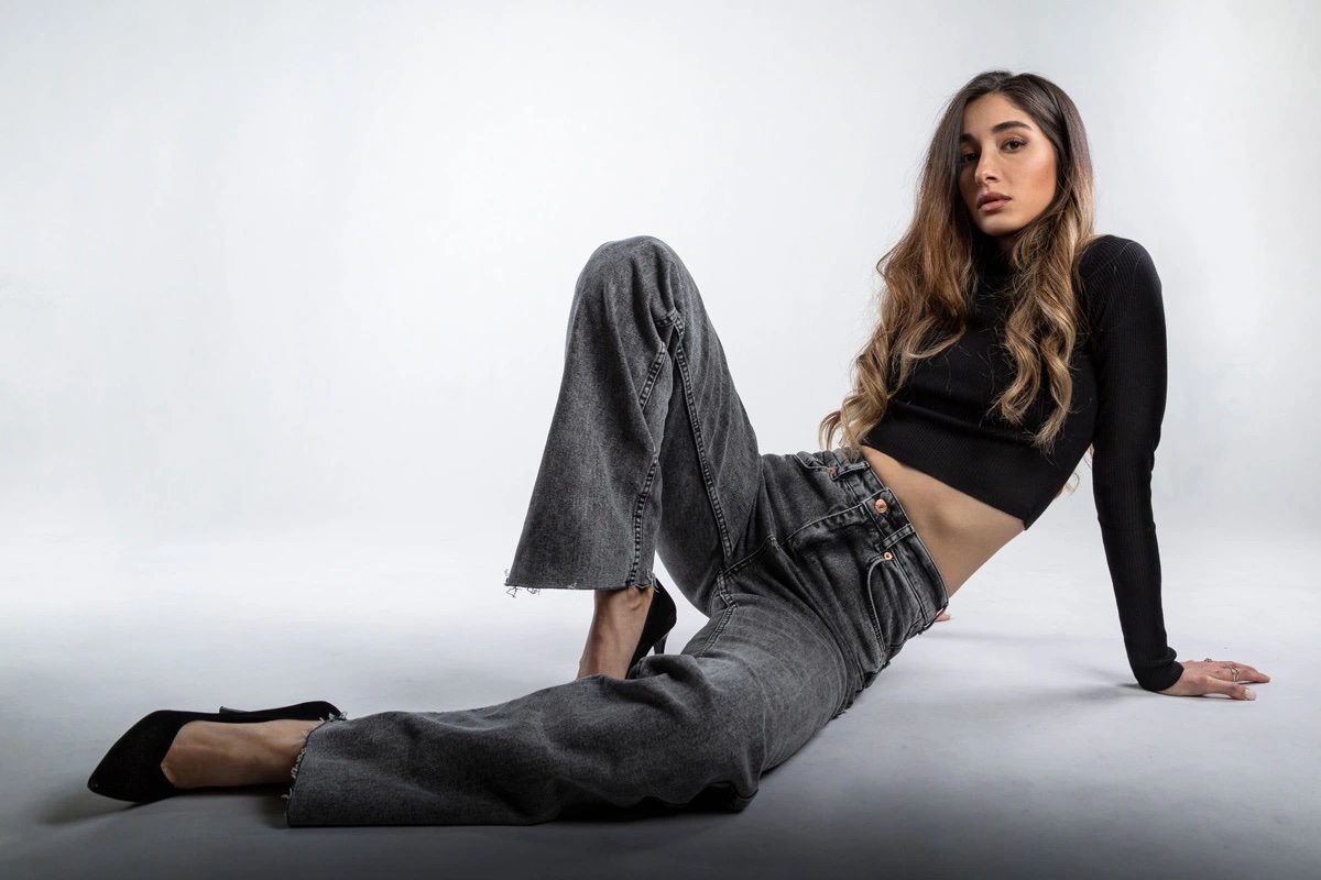 Customer in washed black wide-leg jeans and a black crop top